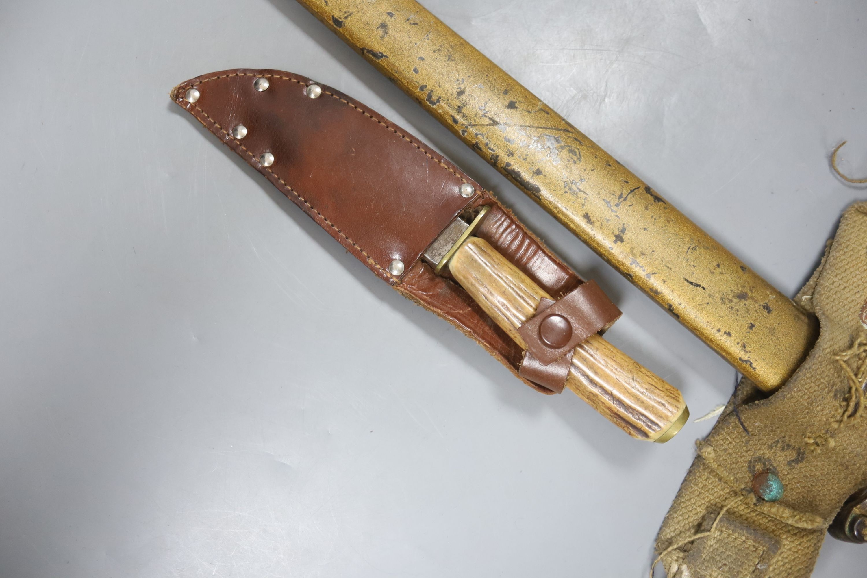 A bayonet with scabbard and a knife, bayonet 71 cms long.